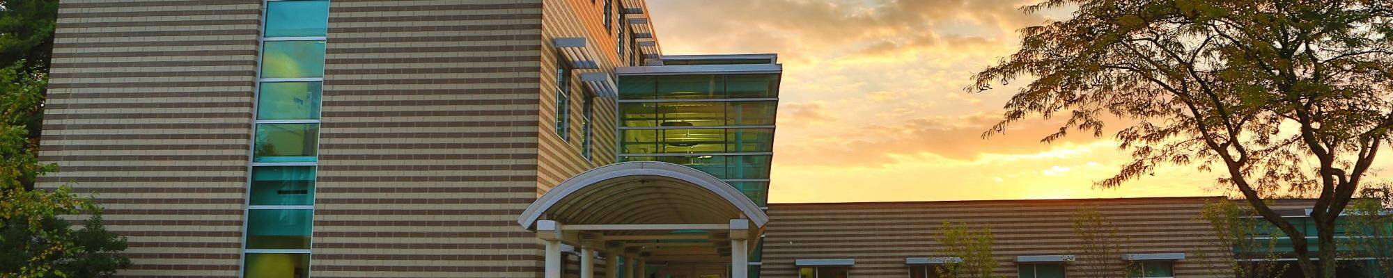 Lake Ontario Hall with the sun setting behind it